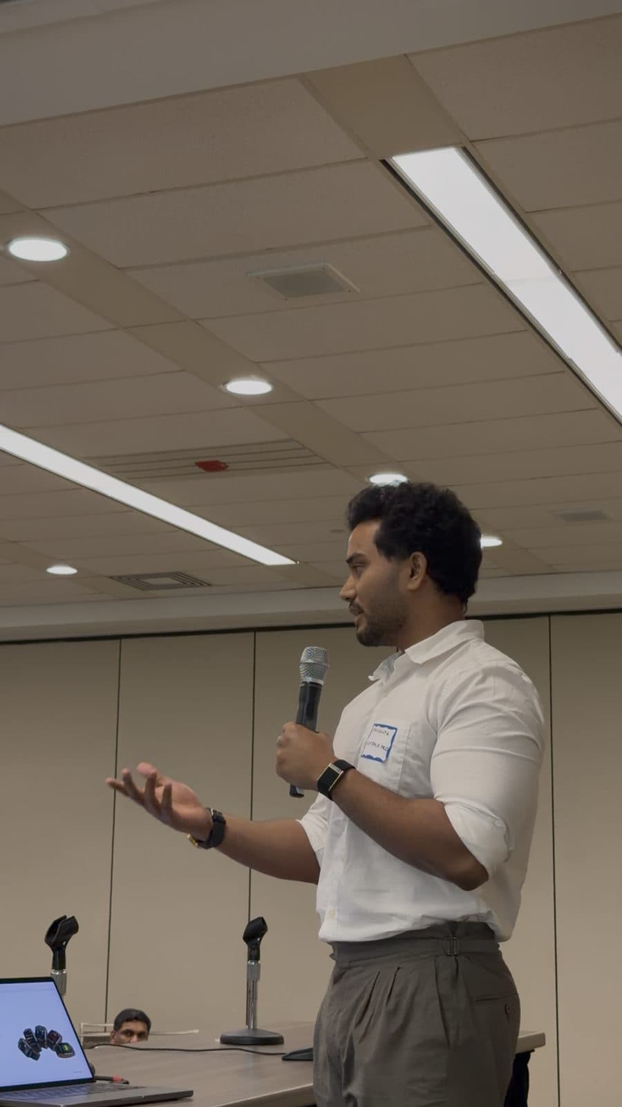 Manikanta pitching ZEALO with a microphone at ATA × IdeaBazz