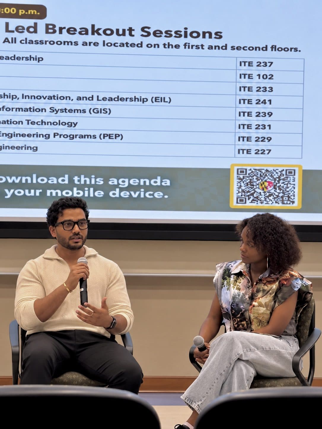 Manikanta answering a question beside another panelist